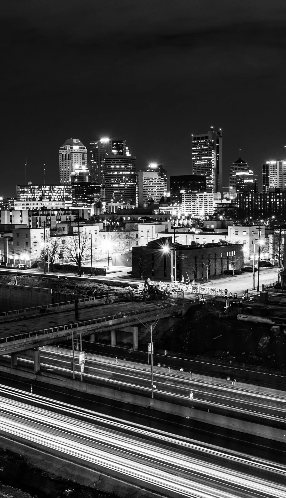 A city at night, seen from above the rail lines