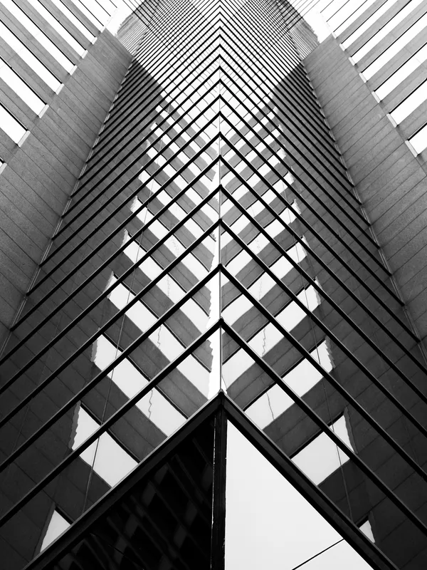Looking up the glass facade of a tower